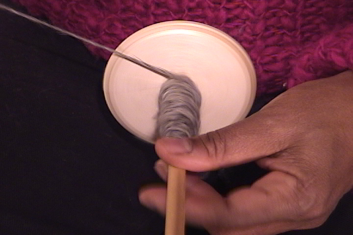 Hand spinning yarn on a drop spindle 